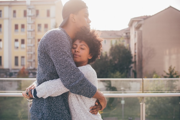 Young multiethnic romantic couple hugging outdoor