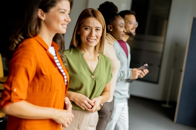 Young multiethnic startup team standing at the modern office