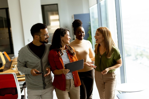 Young multiethnic startup team walking at the modern office