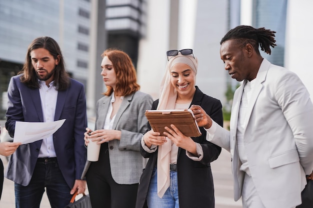 Young multiracial business people working outside of office