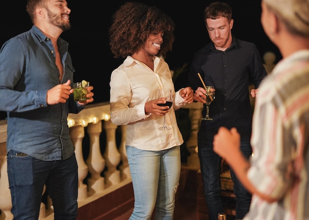 Young multiracial people dancing at home party on terrace field