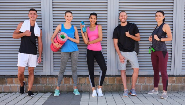 Young multiracial sport team with equipment after workout