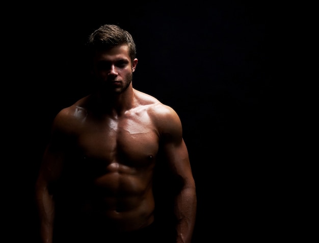 Young muscular fit sportsman posing shirtless