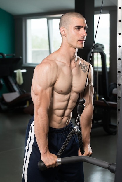 Young Muscular Fitness Bodybuilder Doing Heavy Weight Exercise For Triceps In The Gym