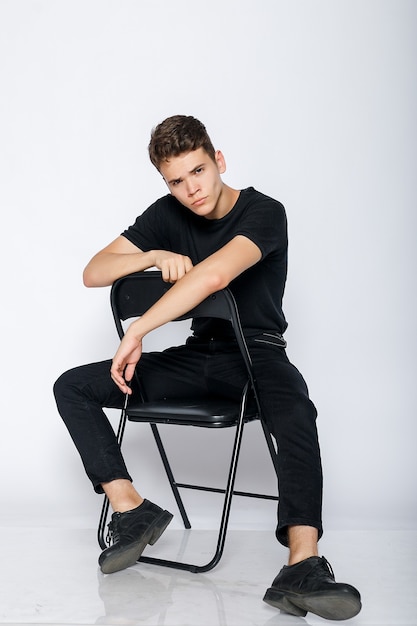 Young muscular man in a black t-shirt and jeans