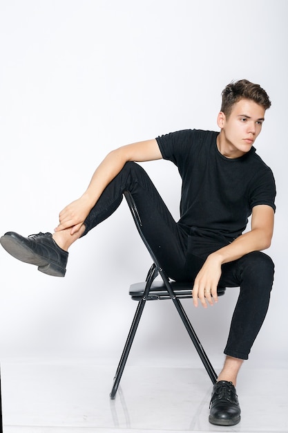 Young muscular man in a black t-shirt and jeans