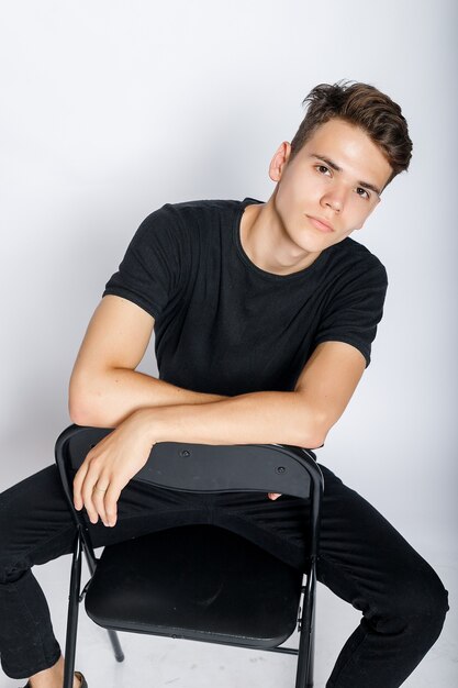 Young muscular man in a black t-shirt and jeans