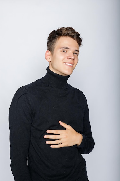 Young muscular man in a black t-shirt and jeans