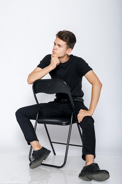 Young muscular man in a black tshirt and jeans