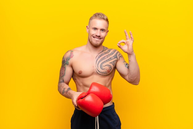 young muscular man showing approval with okay sign