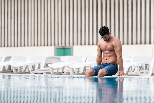 Young Muscular Man At Swimming Outdoor Pool