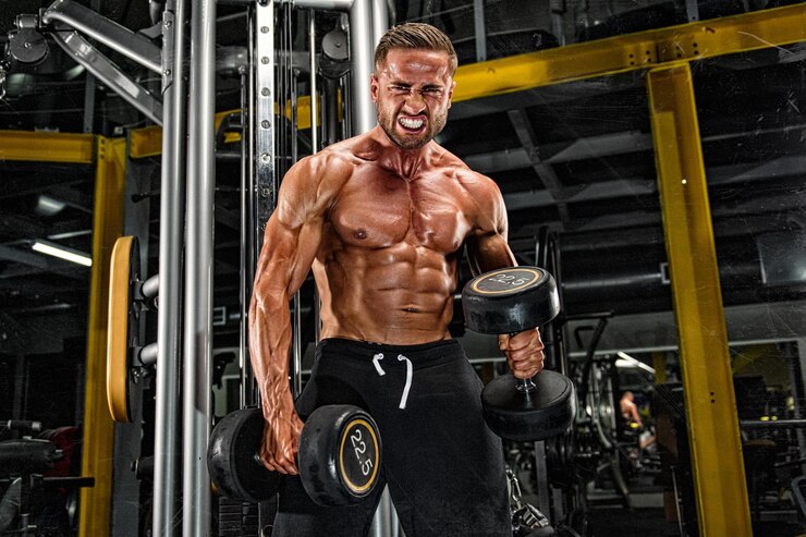 Young Muscular Men Exercise With Dumbbells