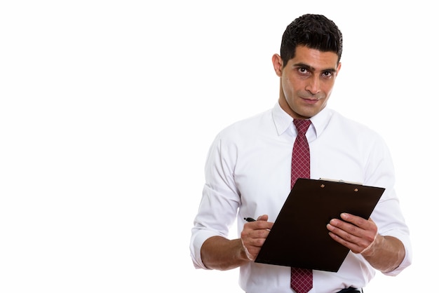 young muscular Persian businessman writing on clipboard