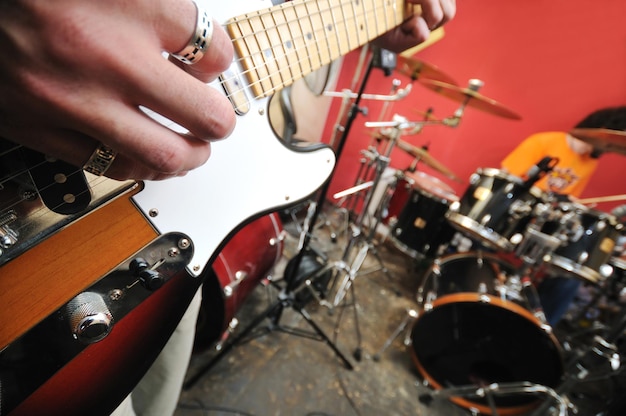 young music player and band friends have training in home garage