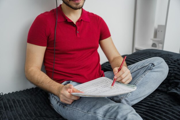 Young musician man studying and composing new music