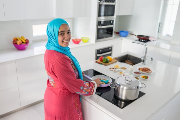 Young Muslim Arabic woman in the kitchen