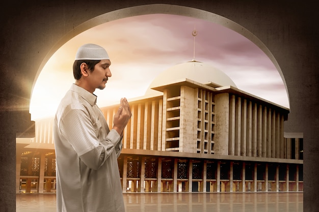 Young muslim asian man praying to god