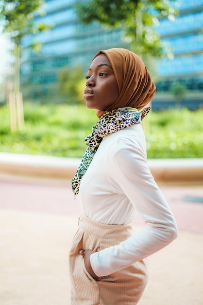 Young muslim black woman in hijab looking aside