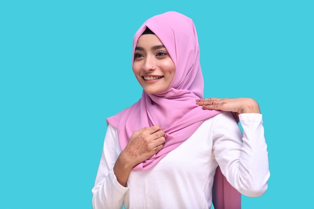 young muslim girl wearing hijab excited over bule background indian pakistani model