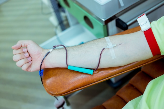 young muslim man donating his blood in hospital