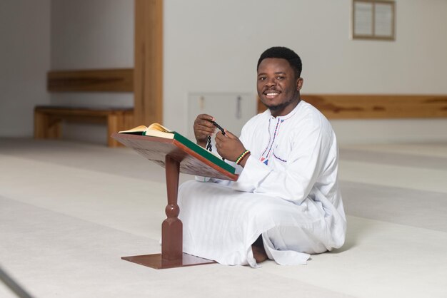 Young Muslim Man Reading The Koran