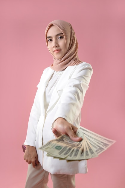 Young muslim woman hold money