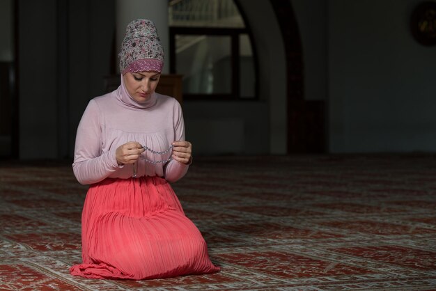 Young Muslim Woman Praying In Mosque