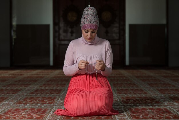 Young Muslim Woman Praying In Mosque