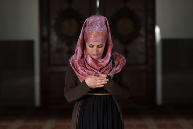 Young Muslim Woman Praying In Mosque