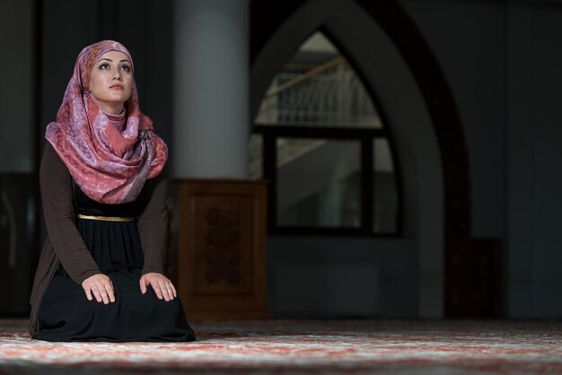 Young Muslim Woman Praying In Mosque