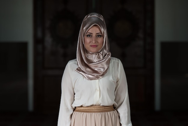 Young Muslim Woman Praying In Mosque