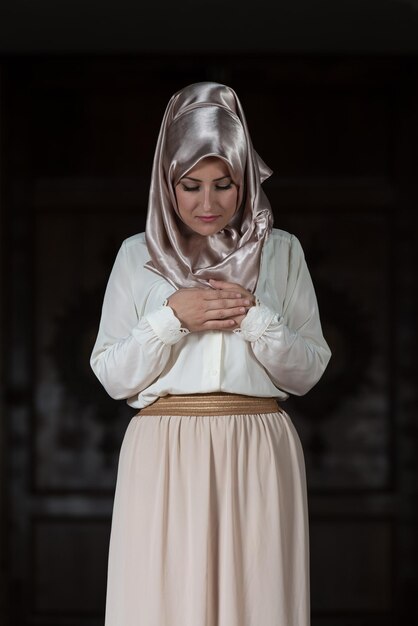 Young Muslim Woman Praying In Mosque