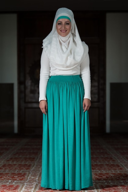 Young Muslim Woman Praying In Mosque