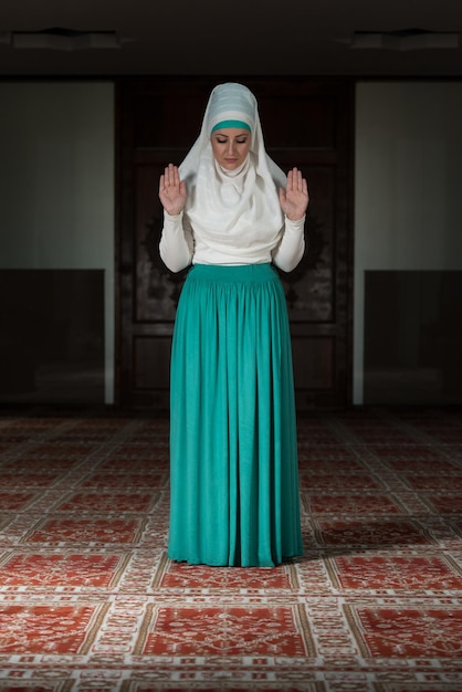 Young Muslim Woman Praying In Mosque