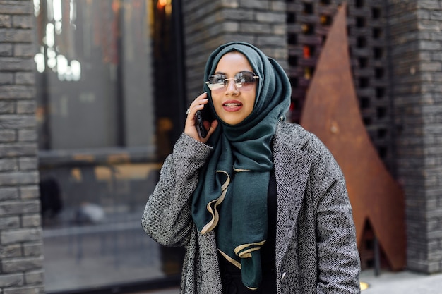 Young muslim woman talking on a phone