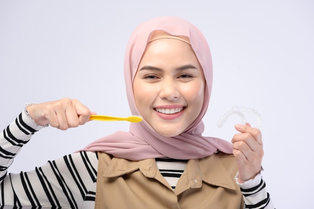 A young Muslim woman using toothbrush with beautiful teeth Dental health care concept