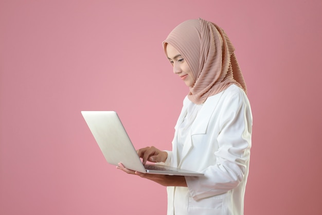 Young muslim woman work online by laptop