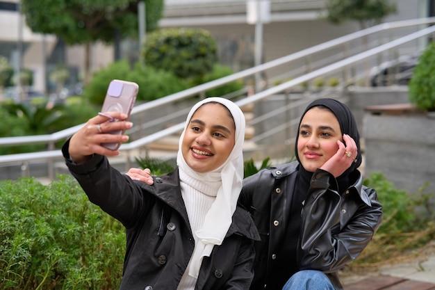 Young muslim women with hijabs taking selfie