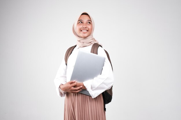 Young muslimah female student is carrying laptop Prepare back to school isolated white background