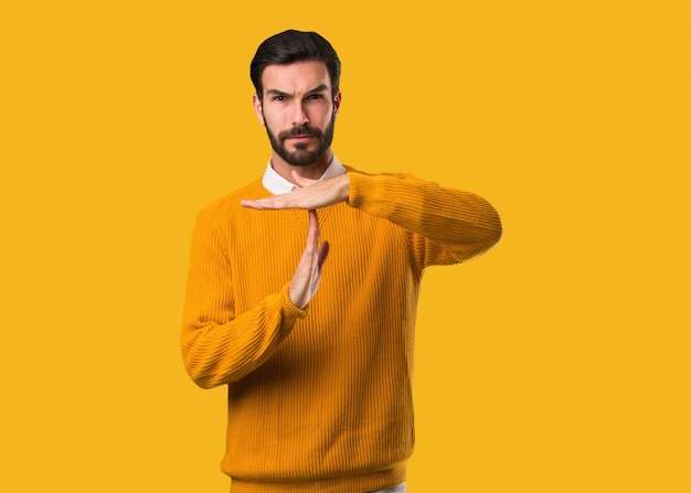 young natural man doing a timeout gesture
