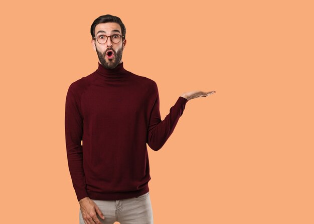 Young natural man holding something on palm hand