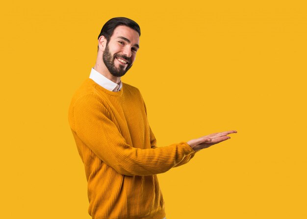 Young natural man holding something with hands