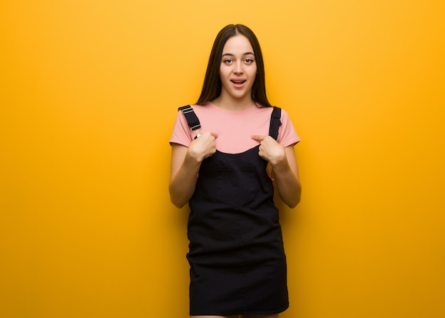 Young natural pretty girl surprised, feels successful and prosperous