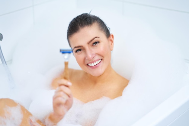 Young nice brunette woman having bath in bathtub High quality photo