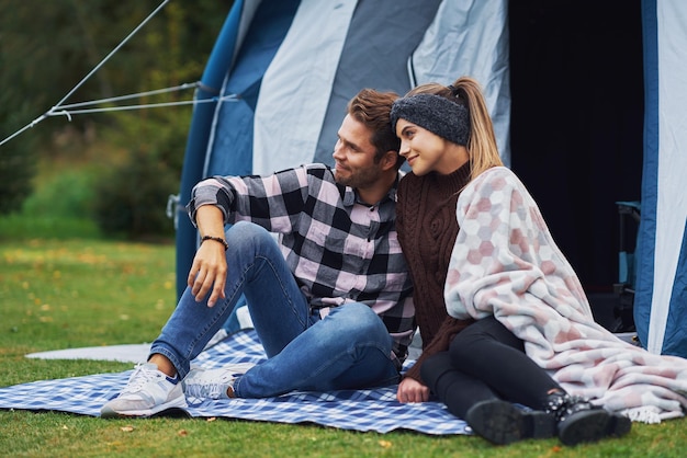 Young nice couple having fun on camping. High quality photo