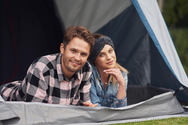 Young nice couple having fun on camping. High quality photo