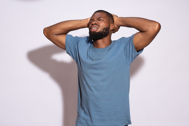 Young nigerian man looking unhappy and worried