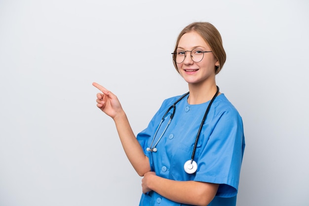 Young nurse doctor woman isolated on white background pointing finger to the side