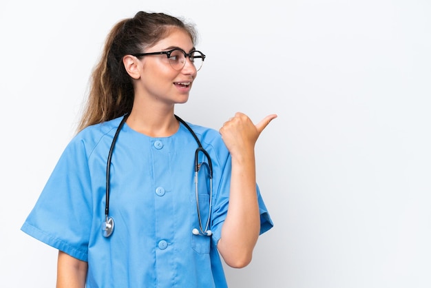 Молодая медсестра-доктор изолирована на белом фоне, указывая в сторону, чтобы представить продукт