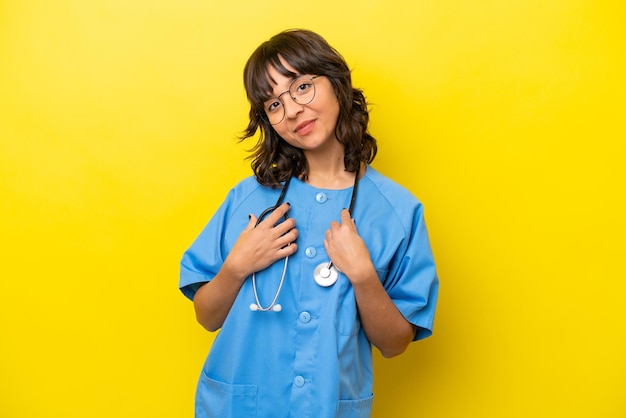 Young nurse doctor woman isolated on yellow background